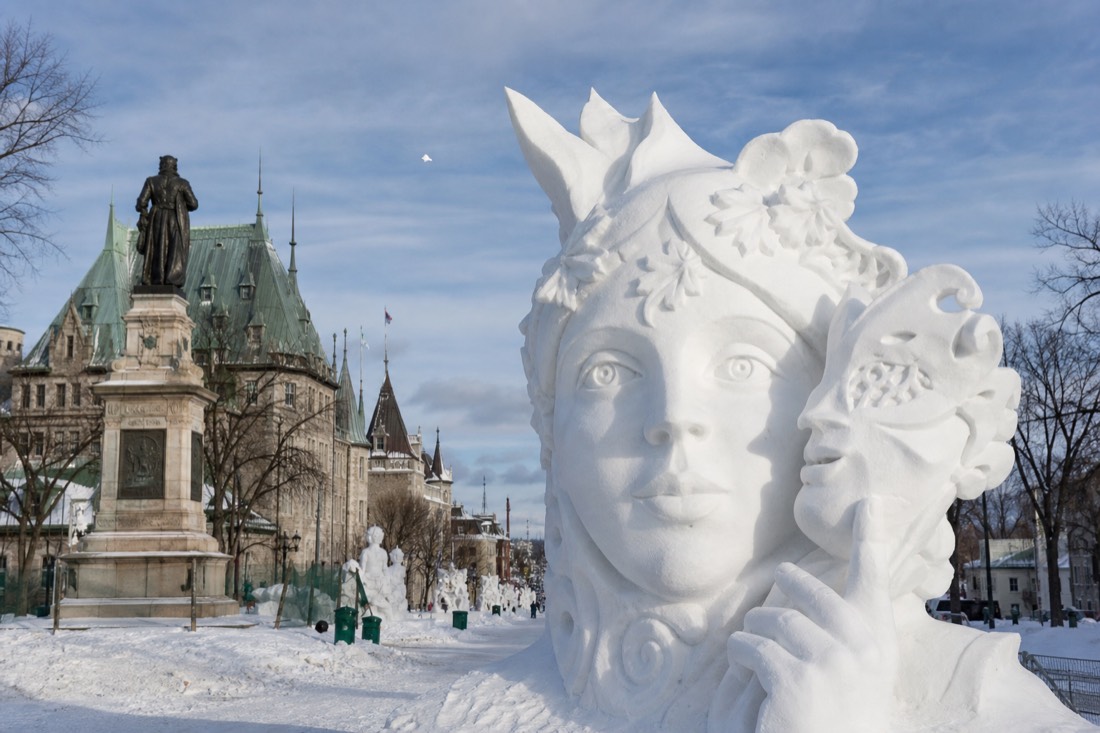Snow sculptures and carnival crowds along Grande Allée during the Quebec Winter Carnival