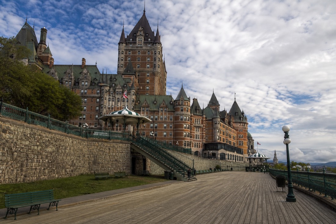 Visitors strolling the Dufferin Terrace boardwalk beneath the Château Frontenac
