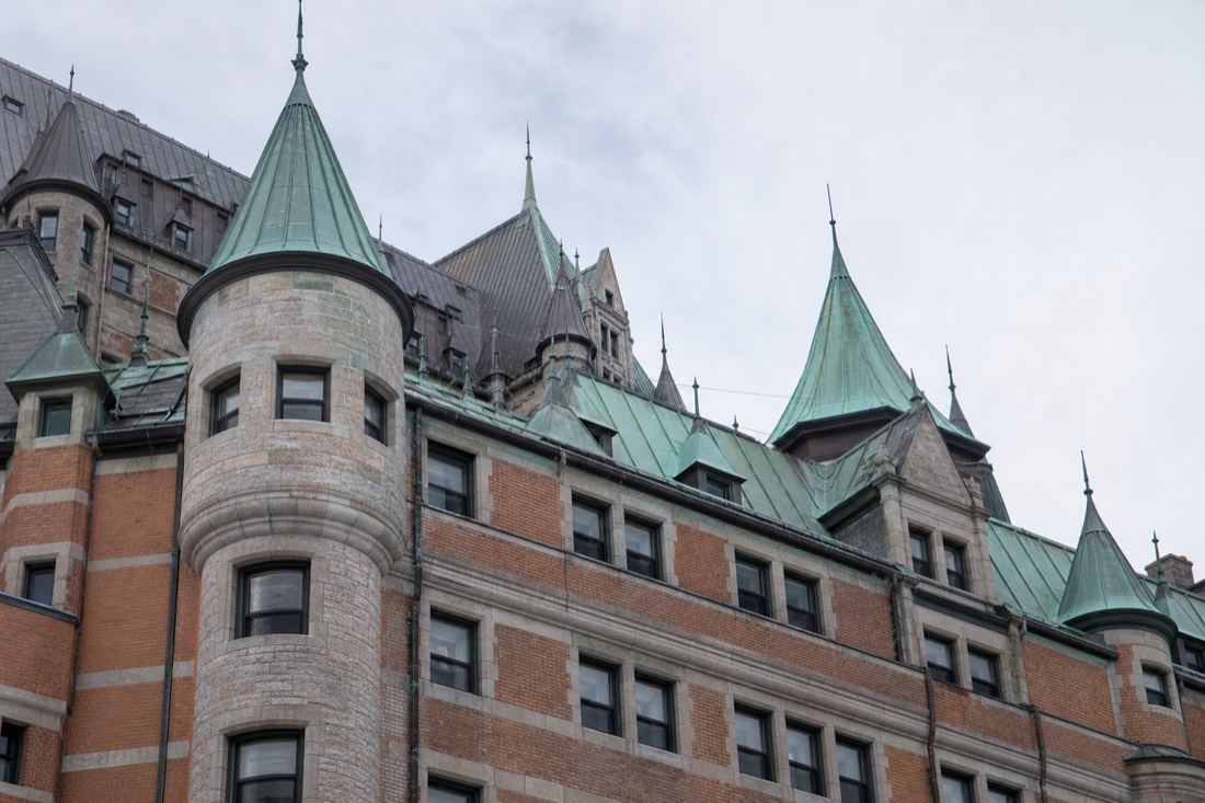 Historic stone and brick facade detail of the Château Frontenac with its steep copper roofline