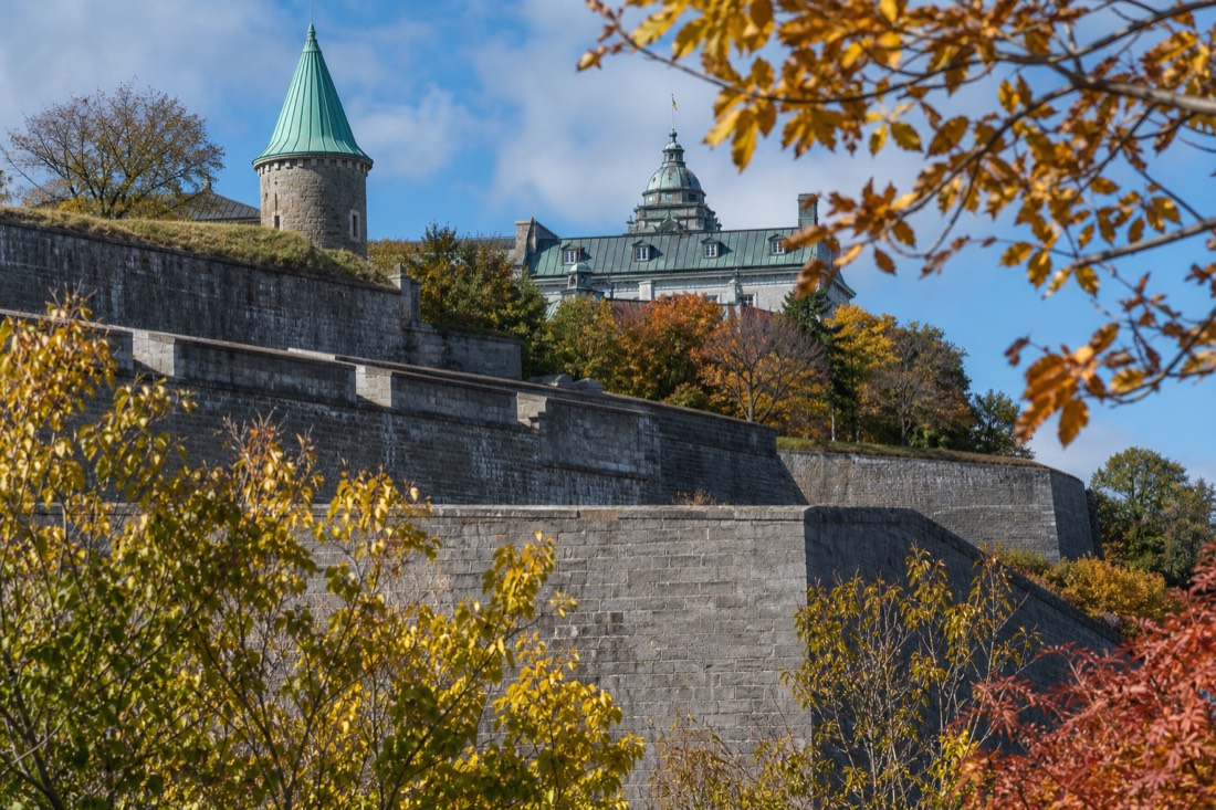 Fall foliage framing the fortification walls of Old Quebec on a clear late September day