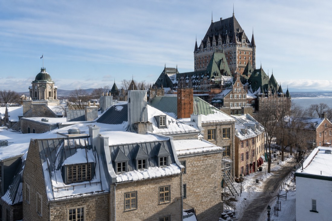 Four-season collage feel: snowy rooftops of Old Quebec under a winter blue sky