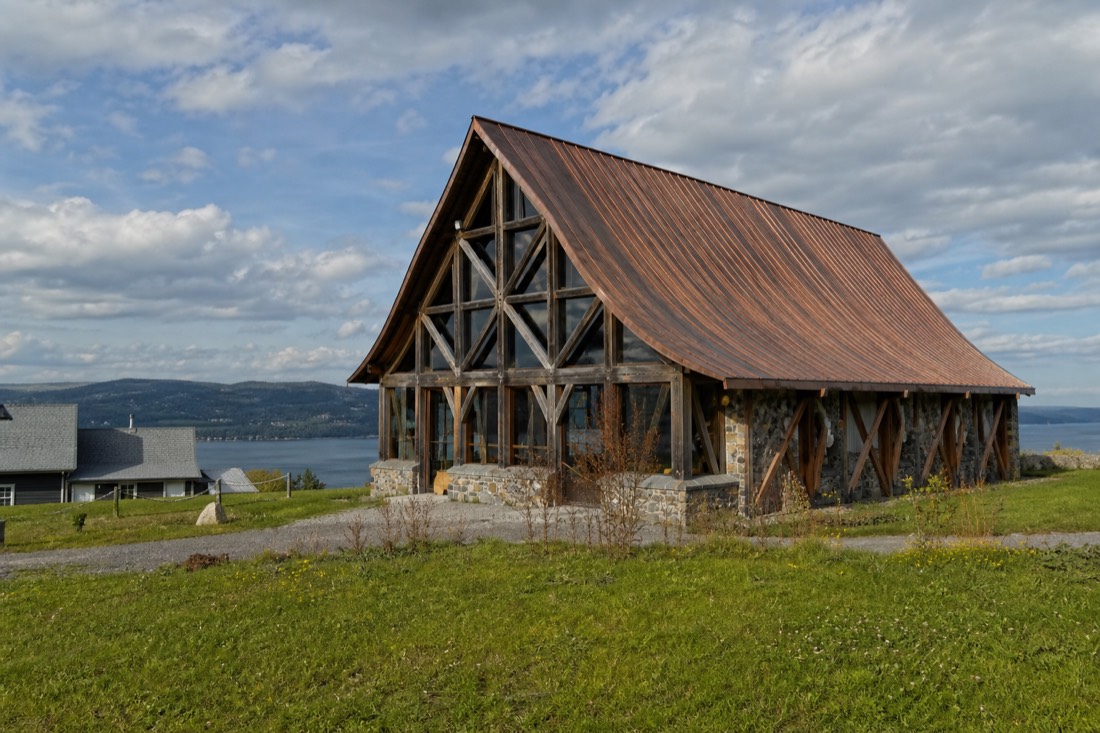 Timber-framed cultural building surrounded by fields in Saint-Pierre on Île d'Orléans, honouring singer Félix Leclerc