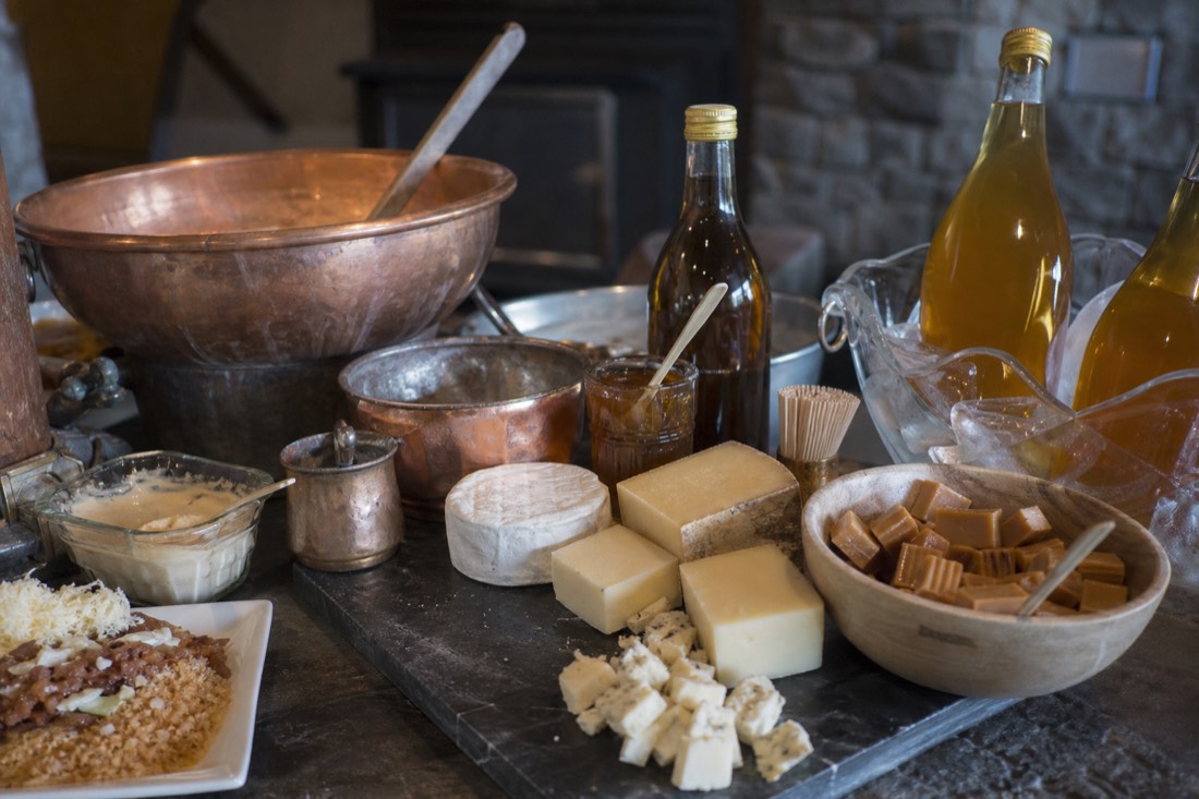 A spread of Quebec specialties, maple products, cheese and cider on a food-tour tasting table