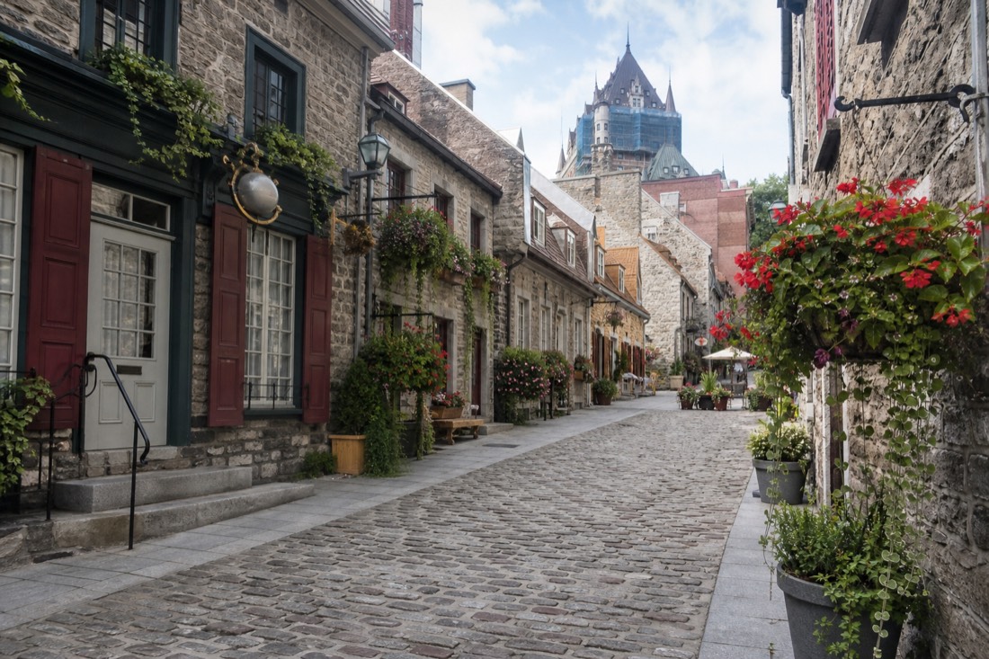 Rue du Petit-Champlain lined with boutiques and hanging flower baskets in Lower Town Quebec City