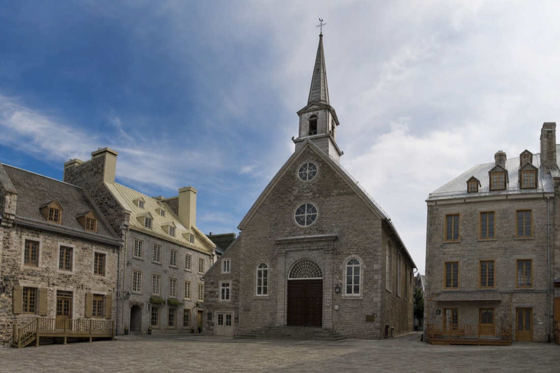 The stone facades and church of Place Royale, the birthplace of French North America, in Old Quebec